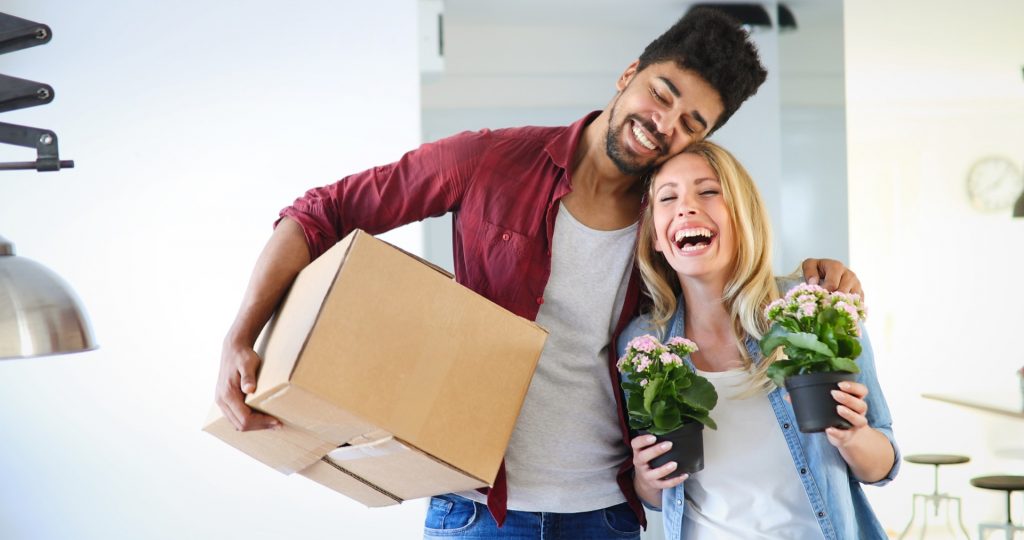 Couple enjoying their new luxurious home and hugging at their luxury apartment in downtown Baltimore MD