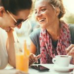 Female friends talking in cafe